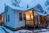 Photo of a house with white siding